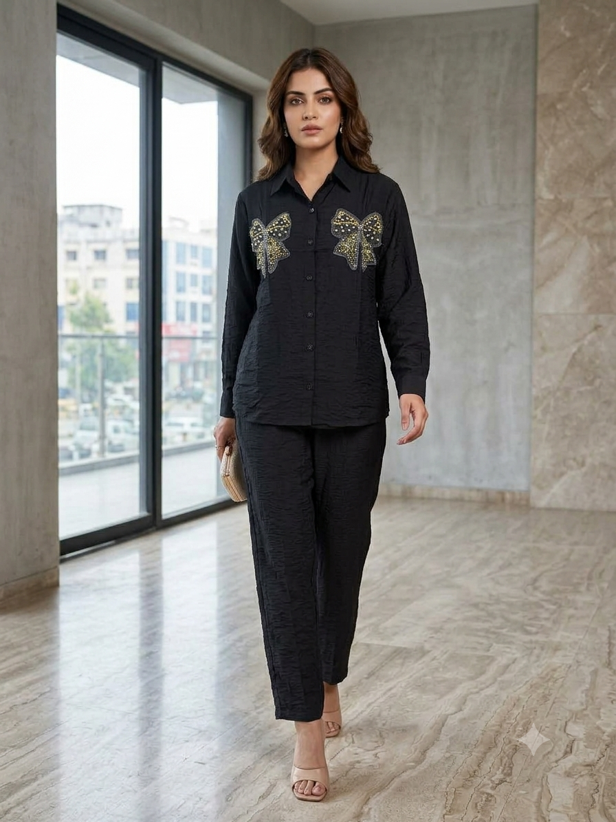 Black button-front shirt with gold-tone embellished bows and matching trousers